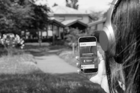 Personne de dos en train d'écouter les podcasts de l'Intefp sur son téléphone portable